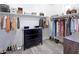 Spacious walk-in closet with ample hanging space, shelving, dresser and stylish wood-look floors at 24042 N 170Th Ln, Surprise, AZ 85387