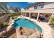 An aerial view showcases the pool, slide, patio, outdoor kitchen and landscaped backyard at 2425 W Woburn Ln, Phoenix, AZ 85085