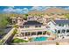 Backyard oasis featuring a pool, outdoor kitchen, covered patio, and beautiful landscaping in a residential community at 2425 W Woburn Ln, Phoenix, AZ 85085