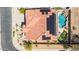 Home featuring a backyard with a custom pool and putting green, complemented by solar panels on the terracotta roof at 2425 W Woburn Ln, Phoenix, AZ 85085