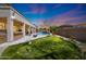 Backyard oasis featuring putting green, covered patio, pool, rock waterfall, and a firepit at 2425 W Woburn Ln, Phoenix, AZ 85085