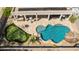 Aerial view of backyard featuring a custom pool, putting green, outdoor kitchen, and covered patio area at 2425 W Woburn Ln, Phoenix, AZ 85085