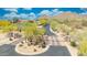 Gated community entrance with stone pillars, desert landscaping, and a secure entry for privacy at 2425 W Woburn Ln, Phoenix, AZ 85085