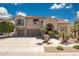 Stunning two-story home featuring lush landscaping, an arched entryway, and a spacious three-car garage at 2425 W Woburn Ln, Phoenix, AZ 85085