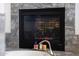 A cozy fireplace with a stone surround is situated next to a soaking tub with luxurious candles adorning the space at 2425 W Woburn Ln, Phoenix, AZ 85085