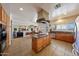 Large kitchen with an island, stainless appliances, and access to the living spaces at 2425 W Woburn Ln, Phoenix, AZ 85085