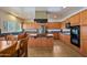 Bright kitchen featuring wood cabinets, center island, and modern appliances at 2425 W Woburn Ln, Phoenix, AZ 85085