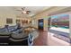 Open living room boasts a built-in bar and access to the backyard pool through glass doors at 2425 W Woburn Ln, Phoenix, AZ 85085