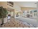 Open-concept living space with fireplace, tall ceilings, and natural light at 2425 W Woburn Ln, Phoenix, AZ 85085