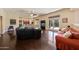 Open living room boasts a built-in bar, dark wood floors, and access to the backyard pool at 2425 W Woburn Ln, Phoenix, AZ 85085