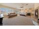 Spacious primary bedroom featuring a cozy fireplace and ample natural light from the many windows at 2425 W Woburn Ln, Phoenix, AZ 85085