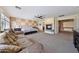 Large primary bedroom with decorative fireplace, sitting area and an ensuite bathroom at 2425 W Woburn Ln, Phoenix, AZ 85085