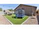 Backyard view with a trampoline, astroturf and a patio set with a firepit, perfect for outdoor activities at 2768 W Jasper Butte Dr, San Tan Valley, AZ 85144