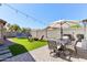 Backyard featuring an outdoor dining area and an artificial turf area with a trampoline at 2768 W Jasper Butte Dr, San Tan Valley, AZ 85144