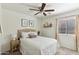 Comfortable bedroom featuring a queen-size bed, neutral decor, and a ceiling fan at 2768 W Jasper Butte Dr, San Tan Valley, AZ 85144
