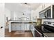 Bright and modern kitchen featuring stainless steel appliances, gray and white cabinets, and ample counter space at 2768 W Jasper Butte Dr, San Tan Valley, AZ 85144