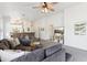 Cozy living room featuring neutral tones, comfortable seating, and a decorative ceiling fan at 2768 W Jasper Butte Dr, San Tan Valley, AZ 85144