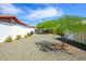 Backyard featuring desert landscaping, mature trees, and a storage shed for tools and equipment at 2901 W Mandalay Ln, Phoenix, AZ 85053