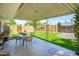 Outdoor patio area with table and chairs, complemented by lush green grass at 2901 W Mandalay Ln, Phoenix, AZ 85053