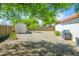 Large backyard featuring desert landscaping and a storage shed for tools and equipment at 2901 W Mandalay Ln, Phoenix, AZ 85053
