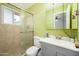 Well-lit bathroom with tiled shower, single sink vanity, and mirrored medicine cabinet at 2901 W Mandalay Ln, Phoenix, AZ 85053