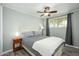 Comfortable bedroom featuring wood-look floors, a ceiling fan, and a bright window view at 2901 W Mandalay Ln, Phoenix, AZ 85053