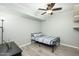 Cozy bedroom features a ceiling fan, wood-look flooring, and ample natural light at 2901 W Mandalay Ln, Phoenix, AZ 85053