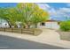 Charming home featuring desert landscaping, a vibrant tree, and a circular driveway at 2901 W Mandalay Ln, Phoenix, AZ 85053