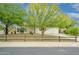 Charming home featuring desert landscaping with vibrant trees and a rustic fence at 2901 W Mandalay Ln, Phoenix, AZ 85053