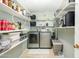 Functional laundry room with washer, dryer, and abundant shelving for storage at 2901 W Mandalay Ln, Phoenix, AZ 85053
