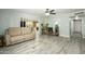 Spacious living room with wood-look flooring, neutral colors, and access to the kitchen at 2901 W Mandalay Ln, Phoenix, AZ 85053