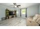 Inviting living room with wood-look floors, ceiling fan, and plenty of natural light at 2901 W Mandalay Ln, Phoenix, AZ 85053