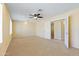 Bedroom featuring carpet, ceiling fan, and large closet with natural light from shuttered windows at 2935 W Kristal Way, Phoenix, AZ 85027