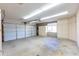 Spacious garage with overhead lighting and built-in storage cabinets at 2935 W Kristal Way, Phoenix, AZ 85027