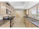 Modern kitchen featuring sleek appliances, tile flooring, and ample counter space at 2935 W Kristal Way, Phoenix, AZ 85027