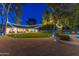 Backyard with lush grass, outdoor seating, and ambient string lighting creating a cozy atmosphere at 3027 W Wescott Dr, Phoenix, AZ 85027