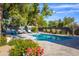 Backyard features a pool, lush landscaping, and outdoor lounge area at 3027 W Wescott Dr, Phoenix, AZ 85027