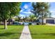 View of the backyard featuring a pool, patio seating, lush lawn, landscaping, and convenient outbuilding at 3027 W Wescott Dr, Phoenix, AZ 85027