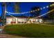 Inviting backyard with string lights, patio seating, and lush lawn, ideal for outdoor gatherings at 3027 W Wescott Dr, Phoenix, AZ 85027