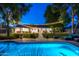 Inviting backyard with a sparkling pool, lush lawn, and charming string lights for relaxed outdoor living at 3027 W Wescott Dr, Phoenix, AZ 85027
