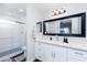 Modern bathroom with white cabinetry, a large mirror, and a glass-enclosed shower at 3027 W Wescott Dr, Phoenix, AZ 85027