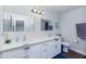Bathroom with dual sinks, white cabinets and countertops, and two mirrors at 3027 W Wescott Dr, Phoenix, AZ 85027
