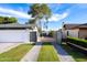 Paver driveway with grass accents leading to a garage and home with secure gate access at 3027 W Wescott Dr, Phoenix, AZ 85027