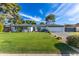 Charming single-story home with a lush green lawn, mature trees, and desert landscaping in a quiet neighborhood at 3027 W Wescott Dr, Phoenix, AZ 85027