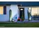 Nighttime shot of the home's entry and desert landscaping, including a brick-paved patio with furniture at 3027 W Wescott Dr, Phoenix, AZ 85027