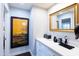 Hallway features white cabinets and countertops, a vanity mirror, and artwork at 3027 W Wescott Dr, Phoenix, AZ 85027