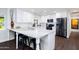 Modern kitchen featuring white cabinets, stainless steel appliances, and a large island with bar seating at 3027 W Wescott Dr, Phoenix, AZ 85027