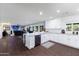 Open-concept kitchen boasts white cabinetry, stainless appliances, and flows into the living area at 3027 W Wescott Dr, Phoenix, AZ 85027