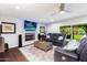 Inviting living room with a fireplace, large TV, comfortable seating, and outdoor access at 3027 W Wescott Dr, Phoenix, AZ 85027