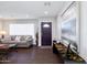 Bright living room featuring neutral tones, wood flooring, a front door, and a large window at 3027 W Wescott Dr, Phoenix, AZ 85027